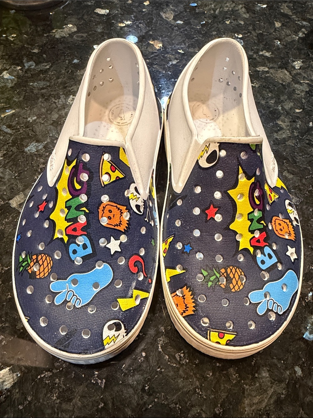 Native Kids Slip-On Shoes in Navy with Multicolor Cartoon Print size 12